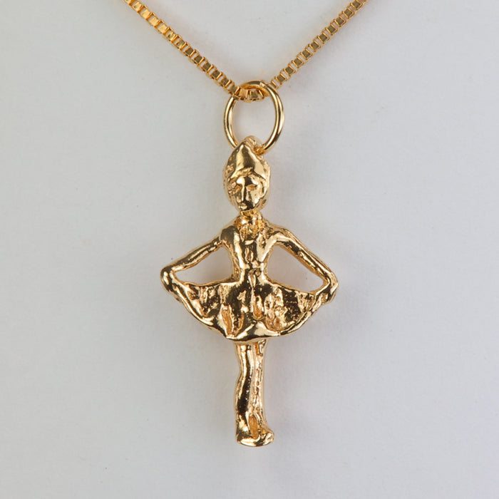 gold pendant with girl doing curtsy