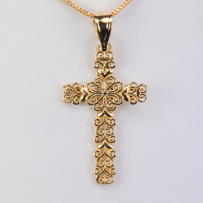 gold cross pendant with filigree design
