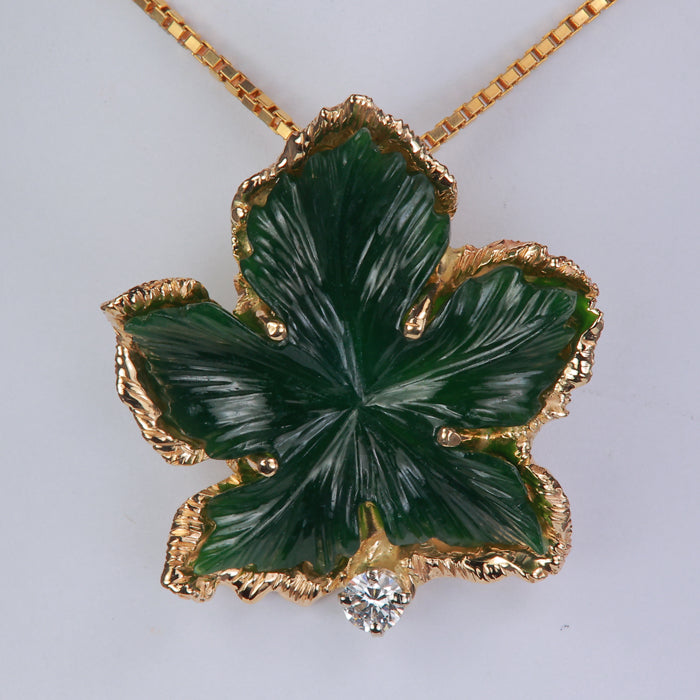 leaf pendant likely jade with diamond accent in yellow gold 
