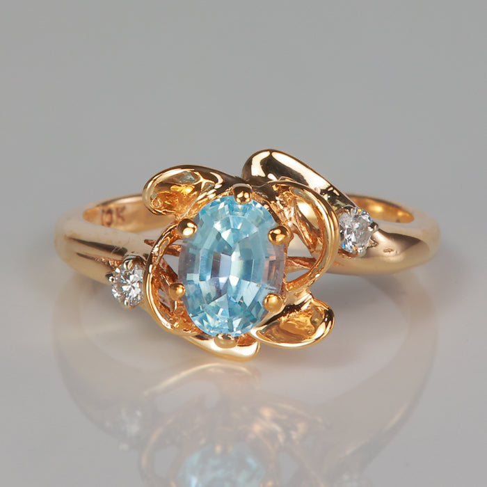 oval cut blue topaz gemstone ring with diamonds in yellow gold