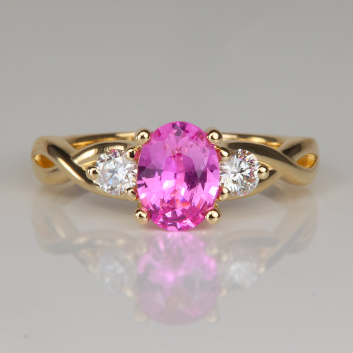 yellow gold ring with oval cut pink sapphire and diamonds 