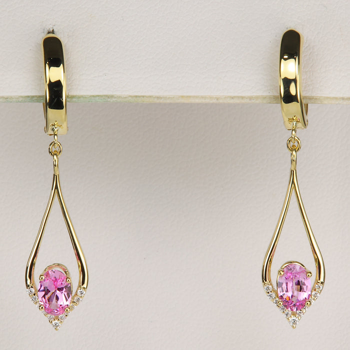 oval cut pink sapphire gemstone earrings in yellow gold with diamond accents