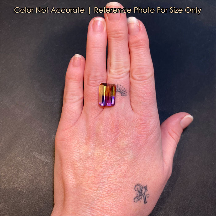purple and yellow ametrine gem on hand