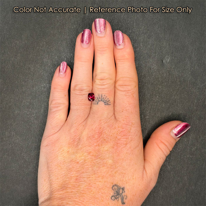 cushion cut ruby gem on hand