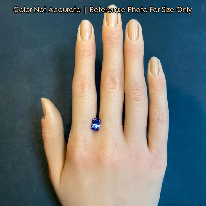 blue violet tanzanite gemstone on hand