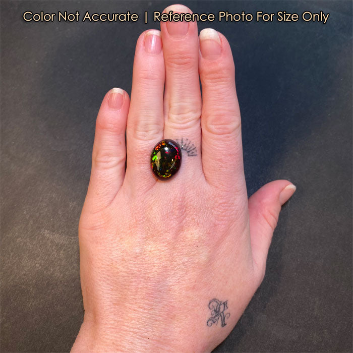 oval black opal gem on hand size 