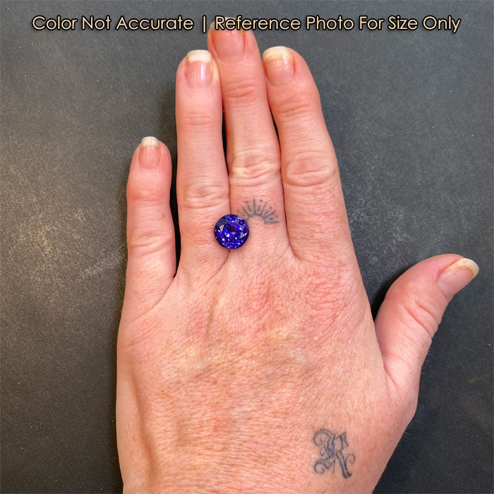 size of blue violet tanzanite to a hand