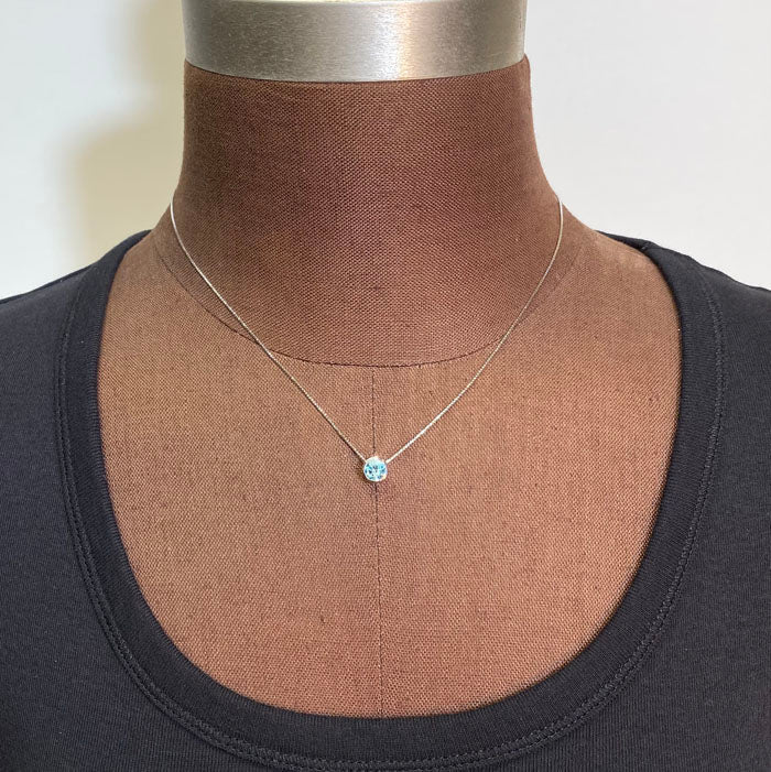 bezel set blue zircon in white gold 