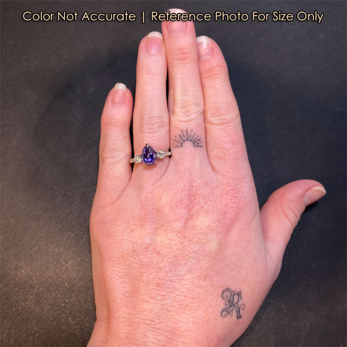 blue violet tanzanite ring in platinum on hand