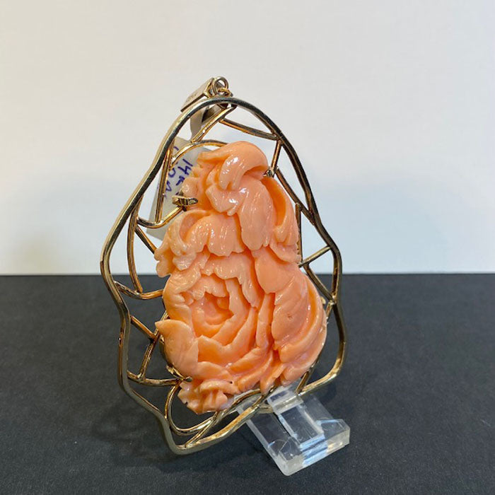 handcarved coral and gold pendant