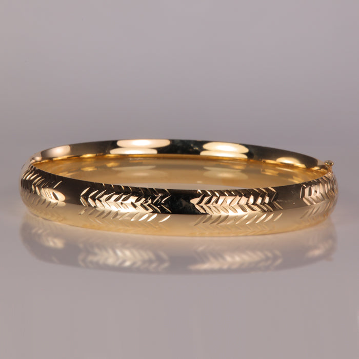 yellow gold estate bangle bracelet with diamond cut chevron design