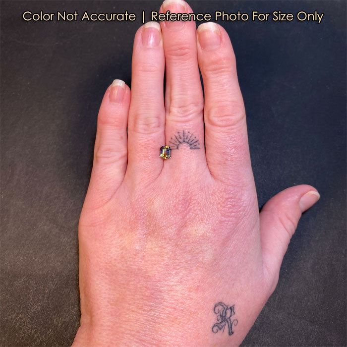 emerald cut sapphire size to hand