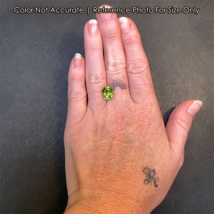 antique cushion peridot gemstone on hand