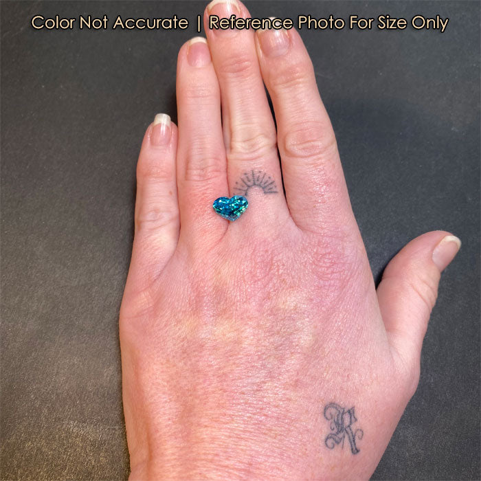 green blue zircon heart shape gem size reference to hand