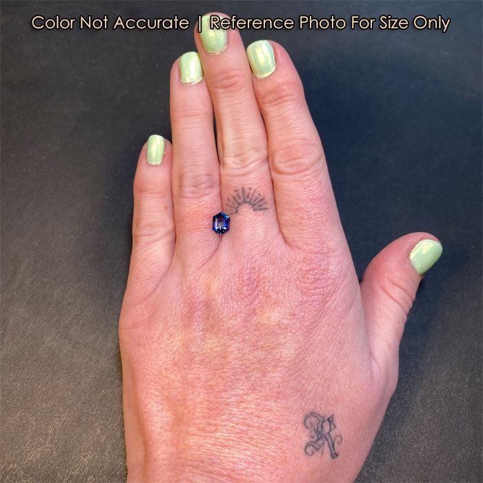 blue hexagon sapphire gem on hand