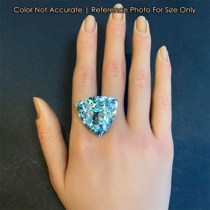 blue green topaz gemstone on a hand 