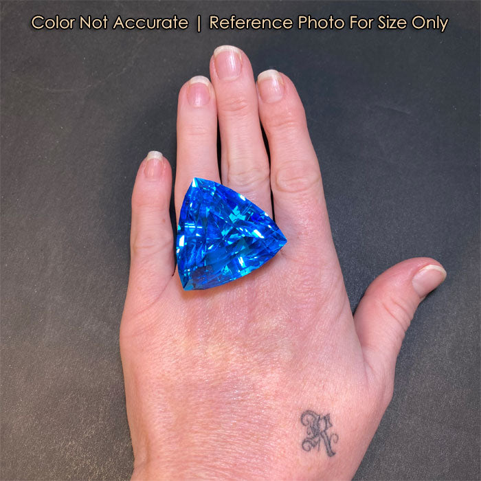 size of trilliant blue topaz to a hand