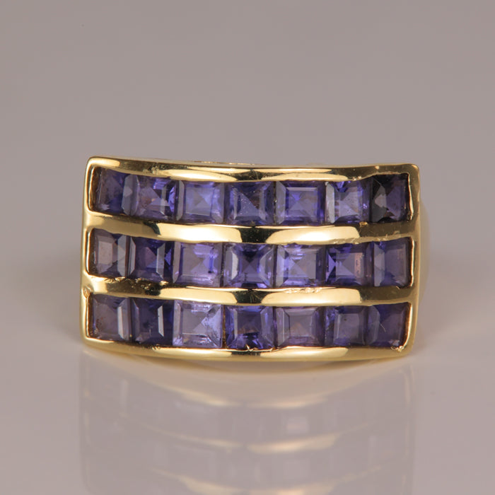 grayish violet gemstone ring in yellow gold most likely iolite 