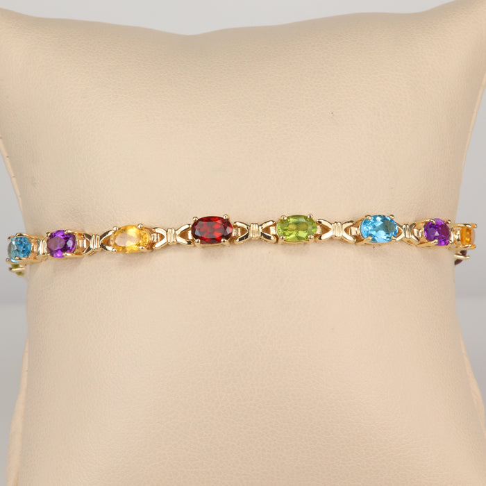 oval cut gemstone bracelet in yellow gold with amethyst, garnet, blue topaz, peridot and citrine