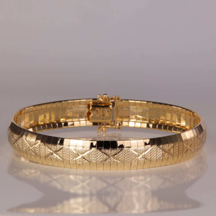 yellow gold omega bracelet with diamond cut x design