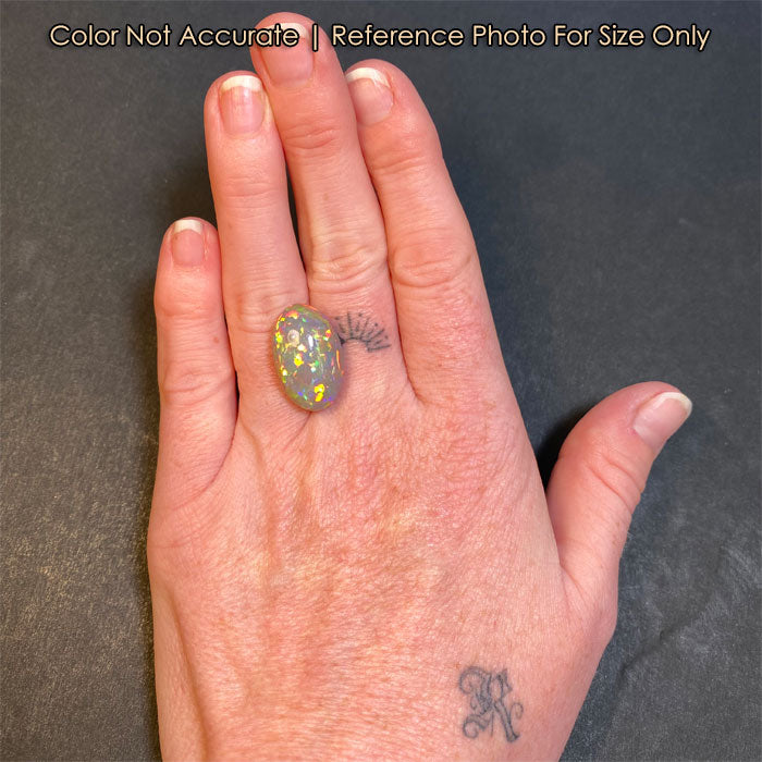 semi black oval opal size to hand