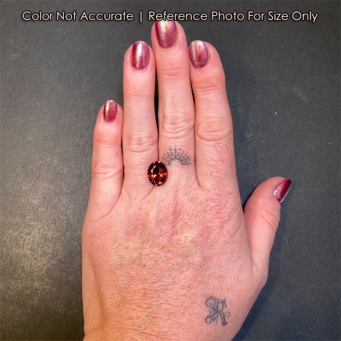 red orange oval garnet size to hand