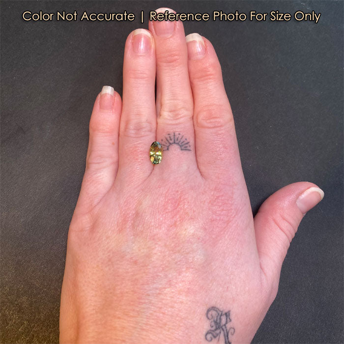 oval bicolor sapphire size to a hand