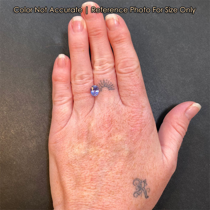 violet color oval sapphire on hand 