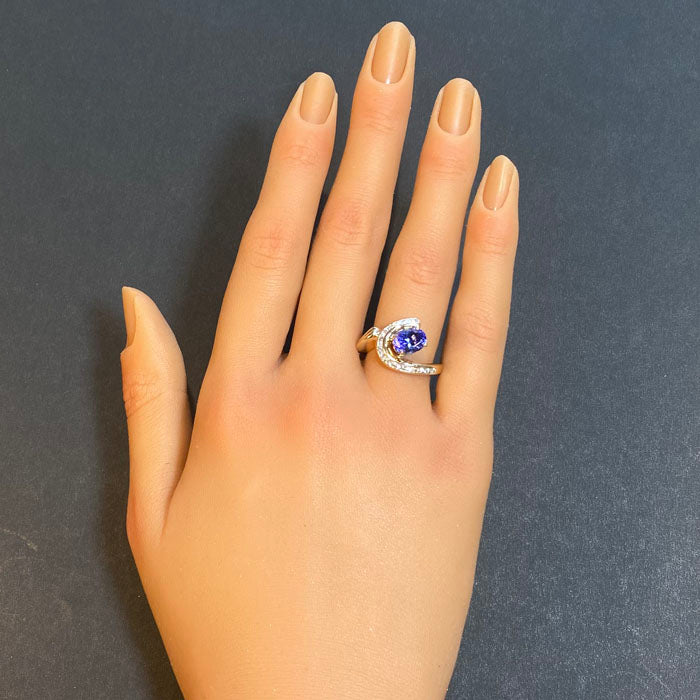 oval tanzanite and channel set diamond ring in yellow gold