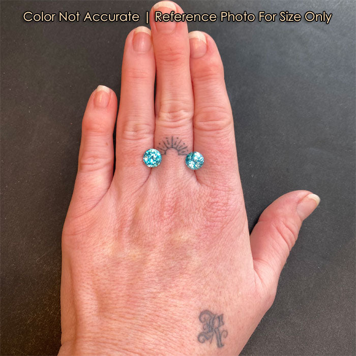 round brilliant blue zircon pair on hand