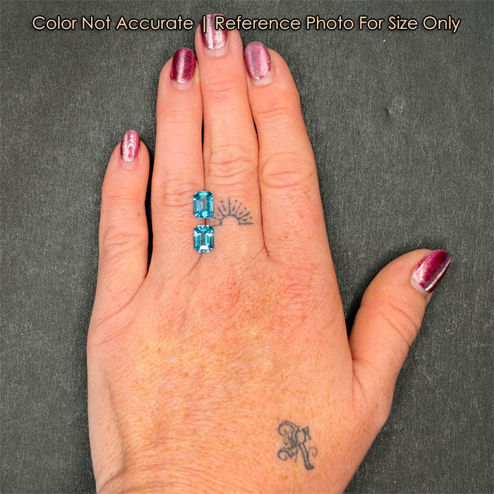 pair of blue zircon gems on hand 