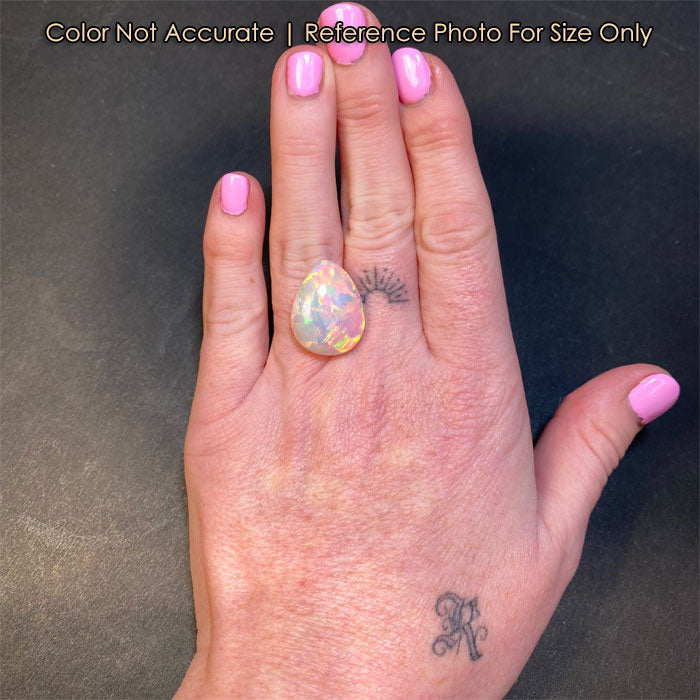opal gem pear shaped on hand size reference