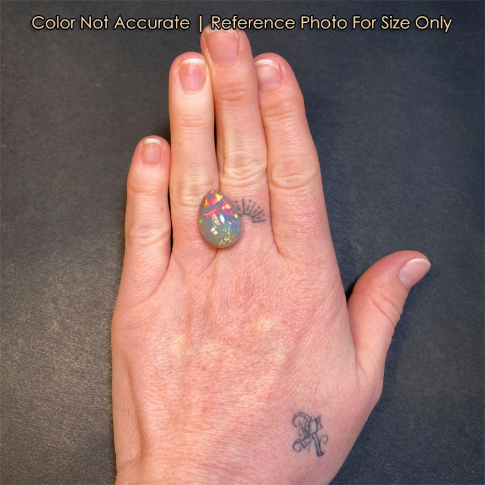 semi black pear opal gemstone size to hand