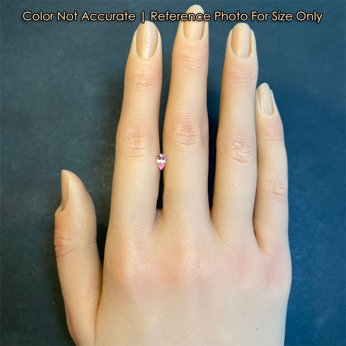 pink color pear shape sapphire gem to hand size