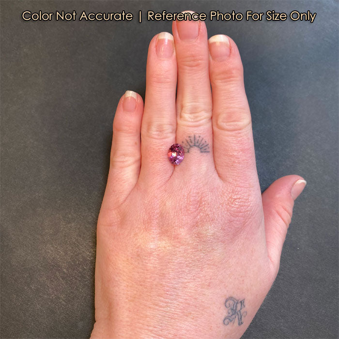 oval cut umbalite garnet on hand size