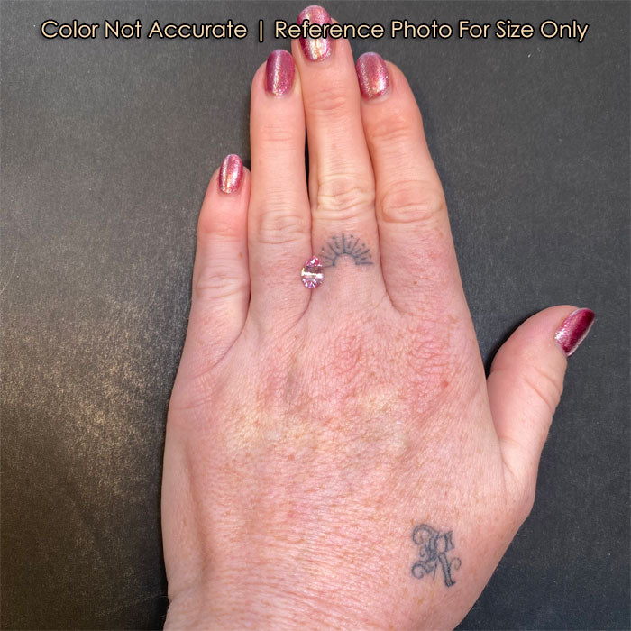 size reference of pink tanzanite on hand