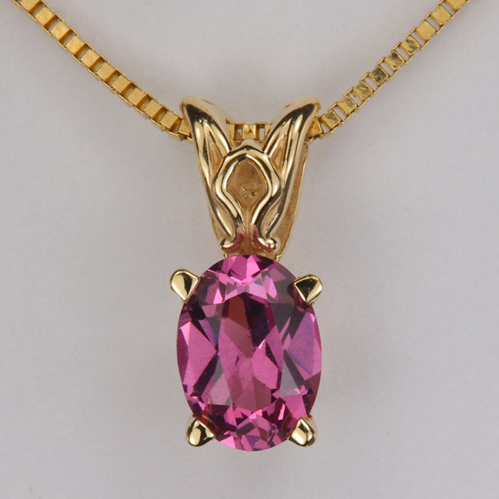 oval cut purple pink color garnet gemstone pendant in yellow gold 