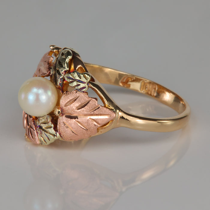 pearl accented ring with leaf design yellow and rose gold