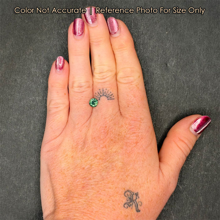 greenish blue color shift sapphire on hand
