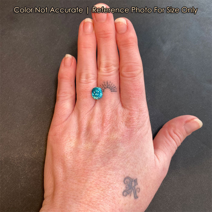 antique cushion blue zircon on hand