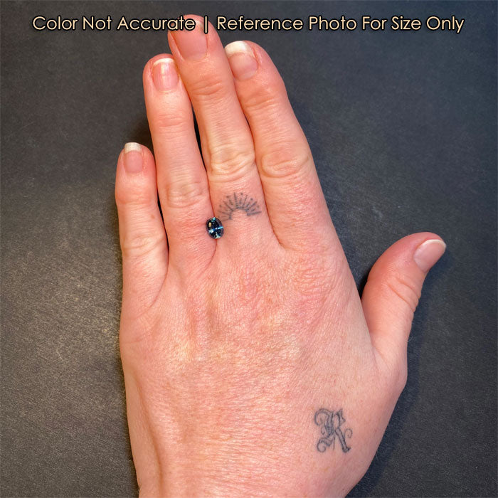 sapphire gemstone on a hand size reference