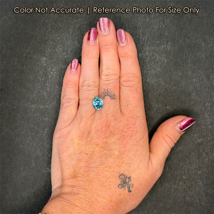 blue zircon step oval cut on hand