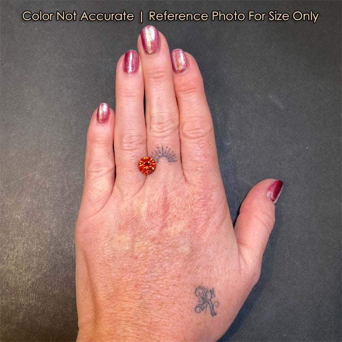 reddish orange round garnet on hand