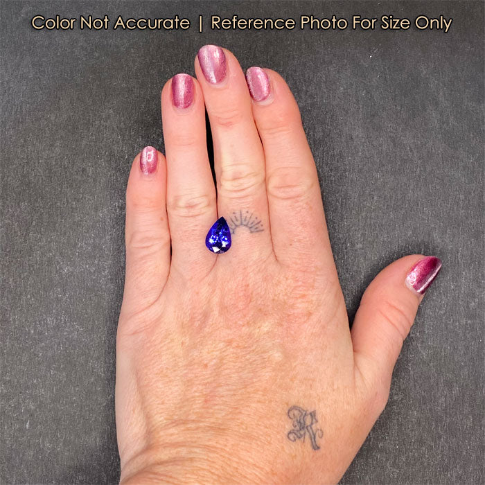 hand size reference of pear tanzanite gem