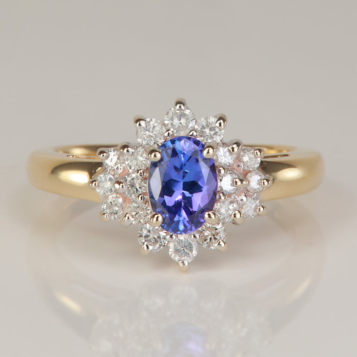 yellow and white gold ring with oval cut blue violet tanzanite gemstone and diamonds