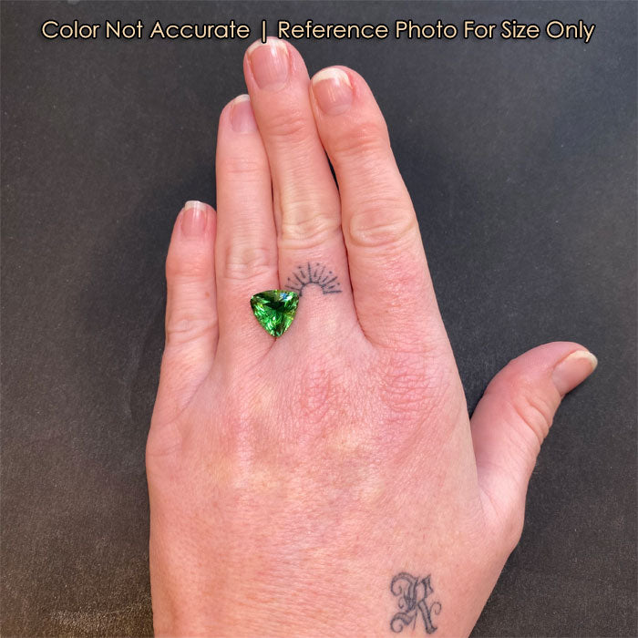 green color tourmaline trilliant cut on hand