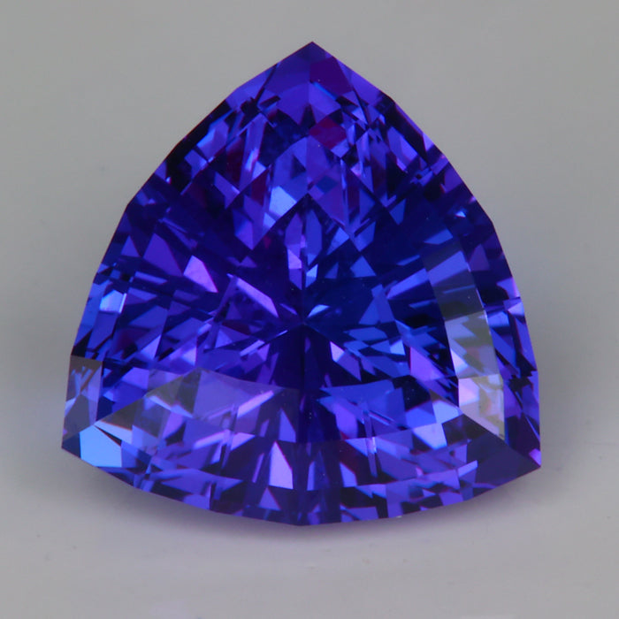 step trilliant cut tanzanite gemstone red flash