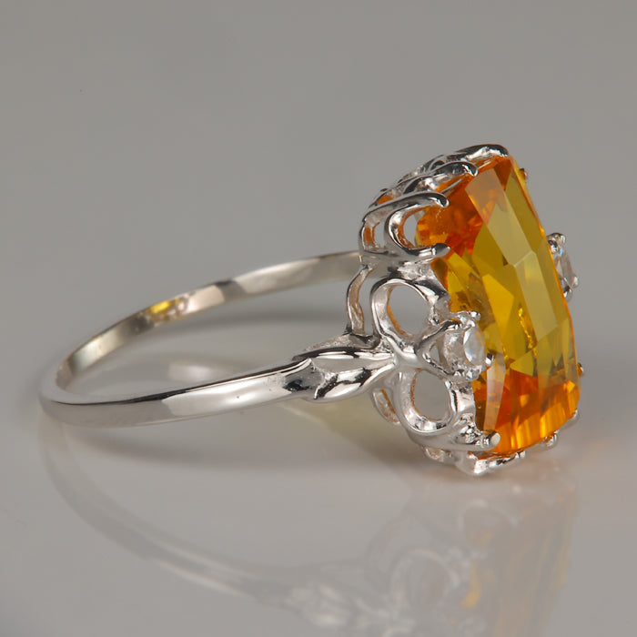 yellow orange synthetic sapphire ring with synthetic white spinel
