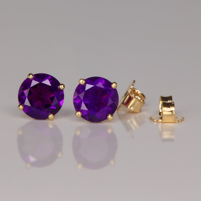 purple color amethyst gemstone earrings in yellow gold