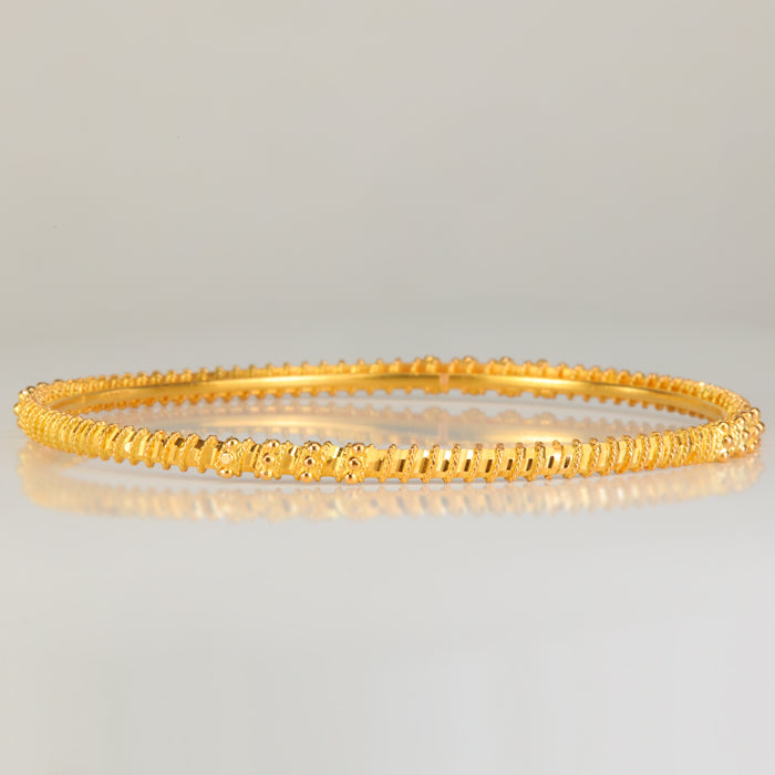 22k yellow gold bangle bracelet with diamond cut and bead details 